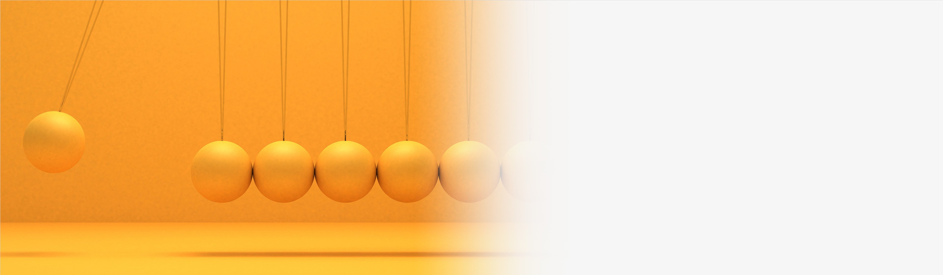 Newton’s cradle with six orange spheres; one sphere is raised, ready to swing.