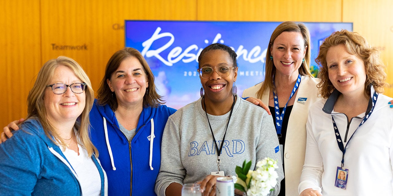 Four Silver LakeAssociates posting for a group photo.